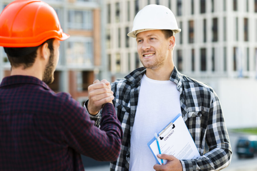 Engineer and architect shaking hands after a site inspection
