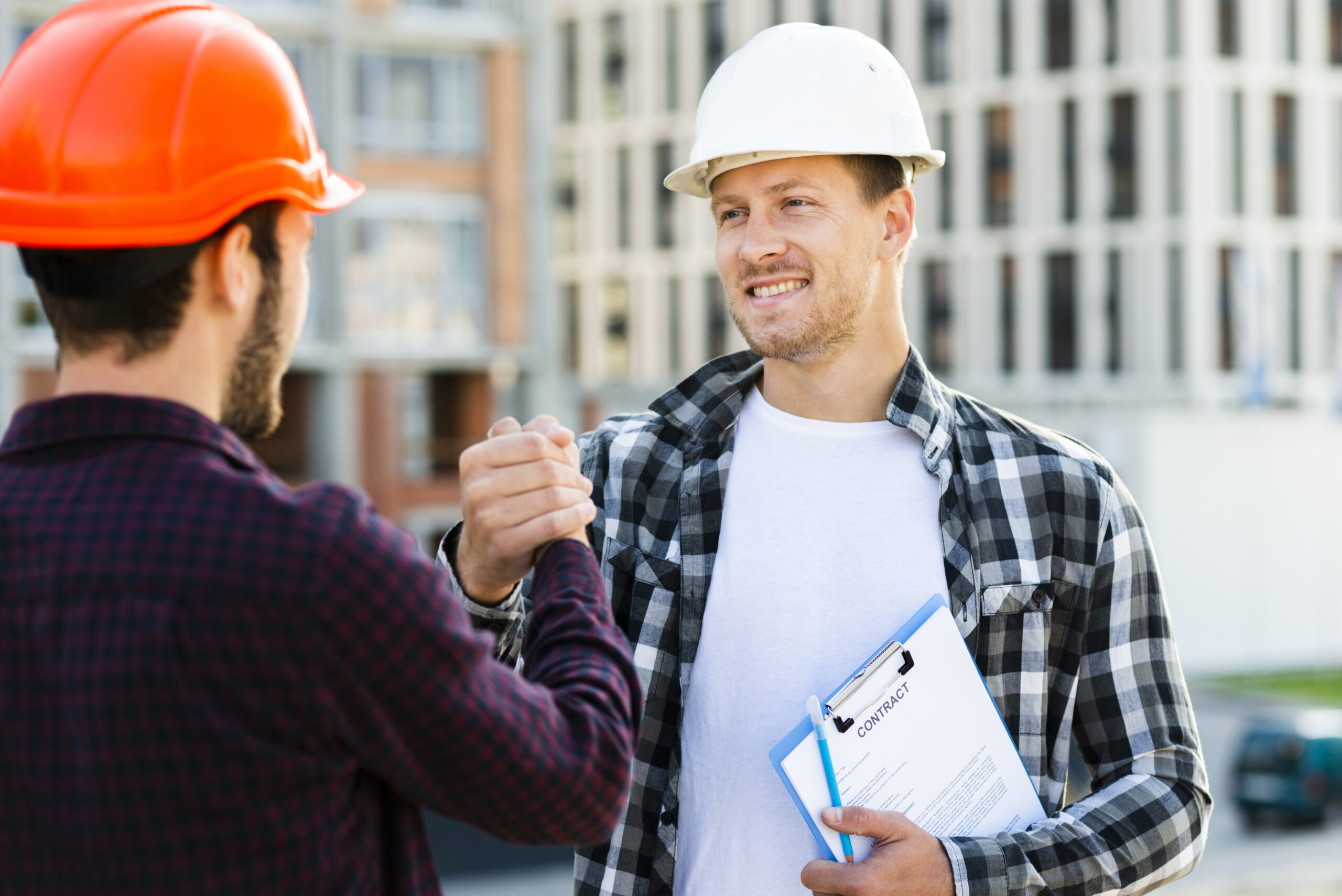 Engineer and architect shaking hands after a site inspection