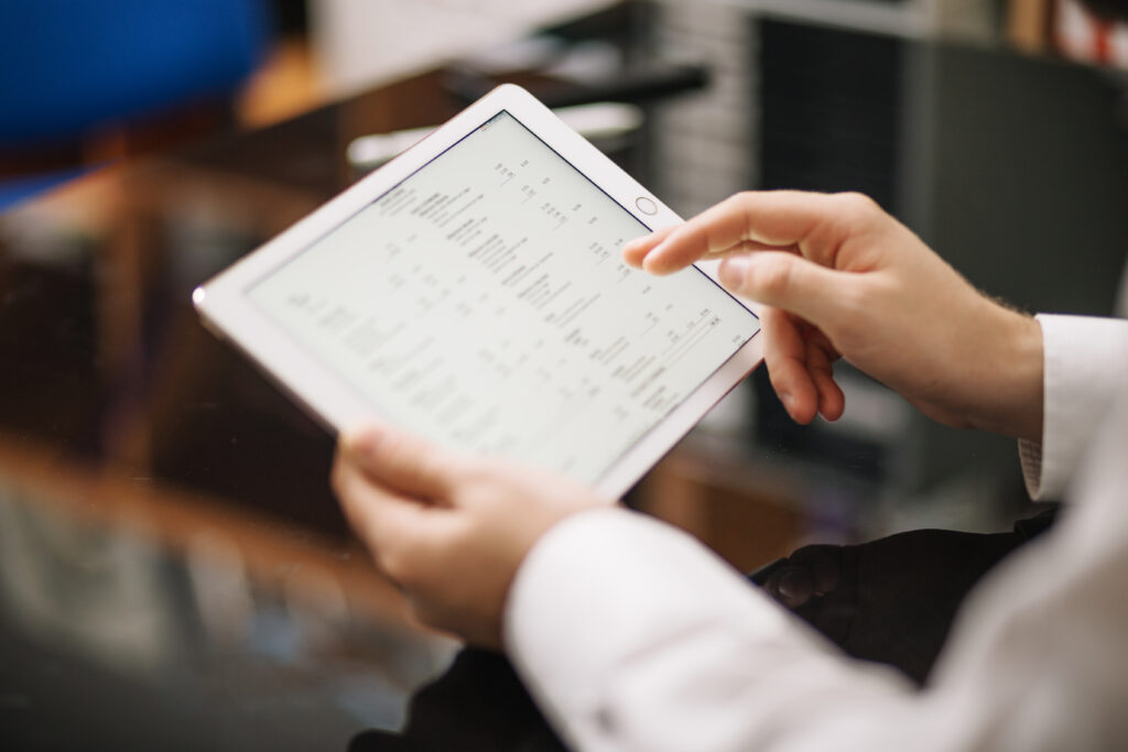 Building inspector reviewing a property report on a tablet
